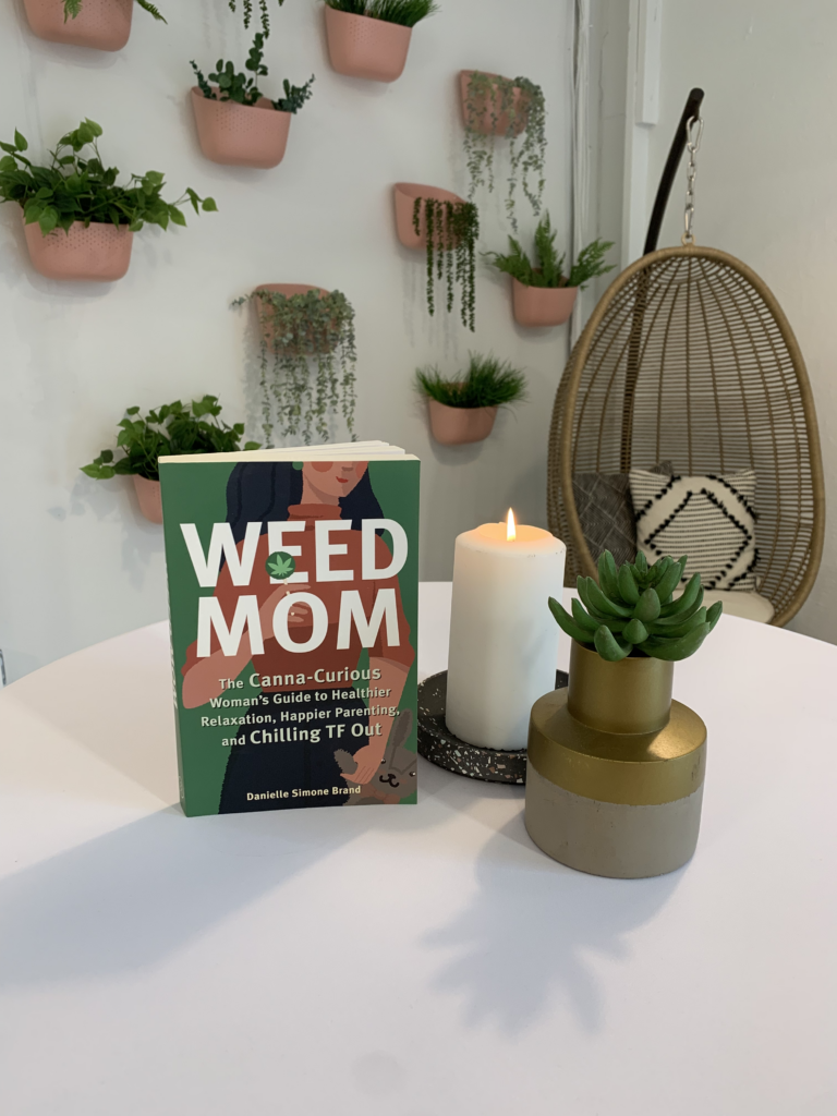 Weed Mom book on table with plants in background